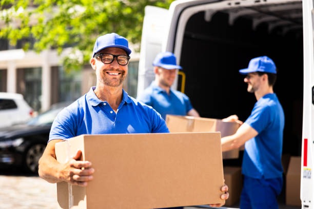 Movers securely loading major home appliances into truck