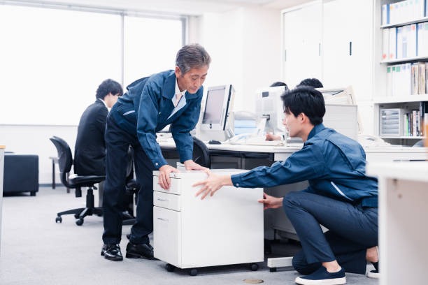 Commercial movers packing office desks and workstations