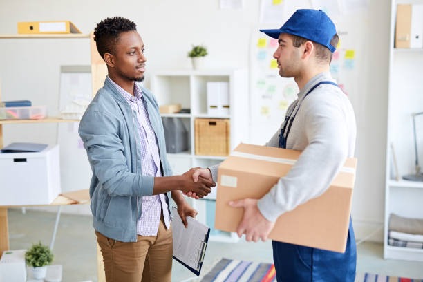 Moving manager shaking hand of satisfied client