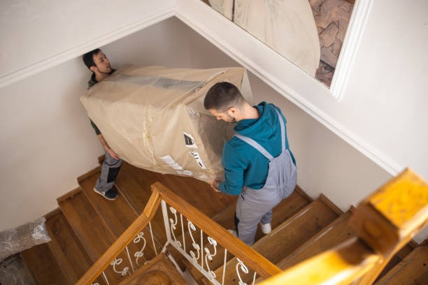 Movers carrying items up narrow stairs